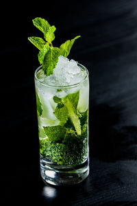 Close-up of beer in glass against black background