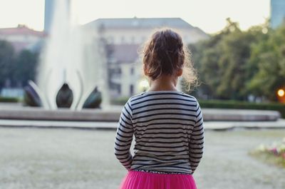 Rear view of girl standing outdoors