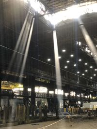 People walking on illuminated street at night