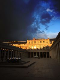 View of illuminated buildings against cloudy sky