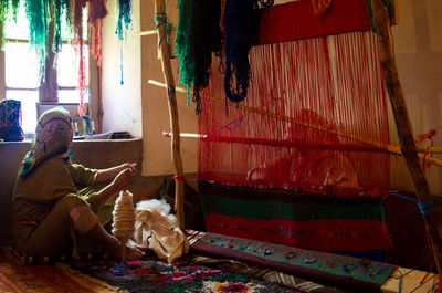 Woman weaving carpet