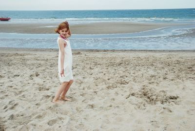 Full length of girl standing on beach