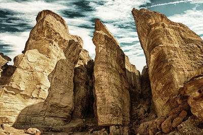 Low angle view of rock formations against sky