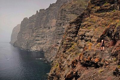 Scenic view of rocky cliffs by sea