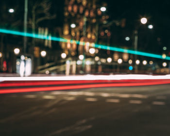 Defocused image of light trails on road at night