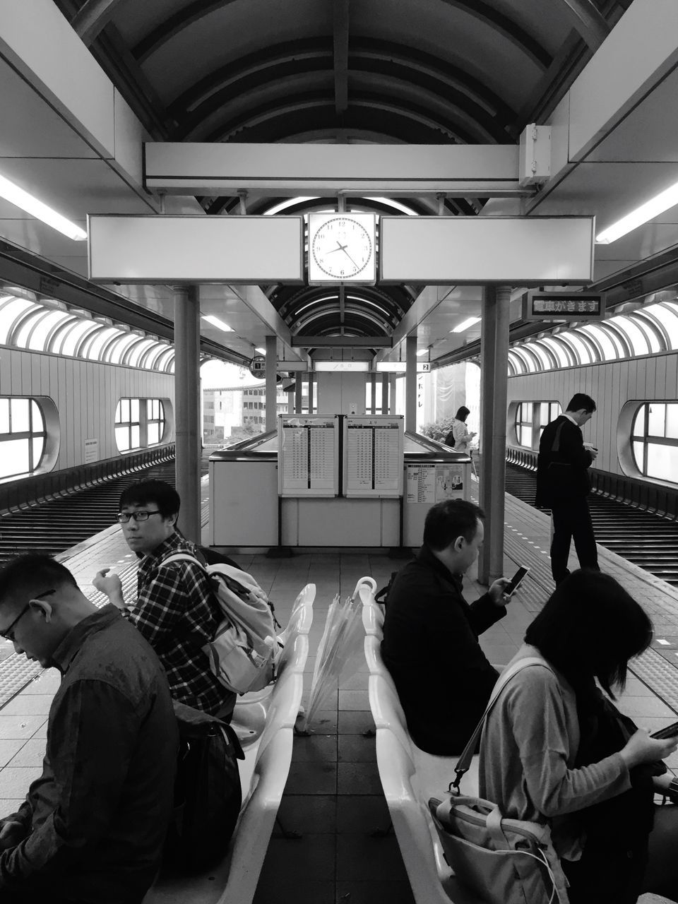 indoors, men, lifestyles, public transportation, leisure activity, person, travel, passenger, rear view, railroad station, transportation, casual clothing, sitting, window, medium group of people, large group of people, journey, architecture, rail transportation