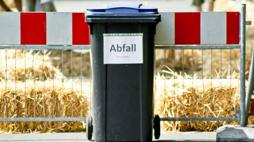 Close-up of text on garbage bin