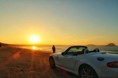 Scenic view of beach against sky during sunset