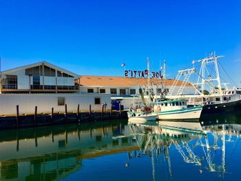 Boats moored at harbor