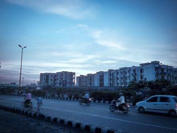 Vehicles on road along buildings