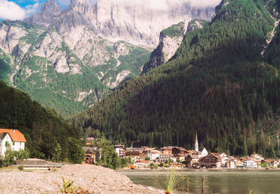 Panoramic shot of trees and buildings against mountains