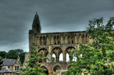 Low angle view of historical building against cloudy sky