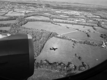 Aerial view of landscape seen through airplane window