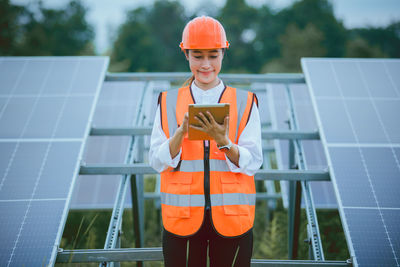 Portrait of young man standing on solar panel