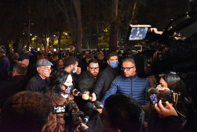 Group of people photographing at night