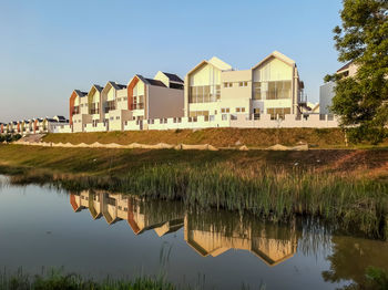 Bright sky with water reflection of terrace houses