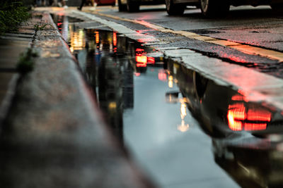 Reflection of illuminated bridge on canal in city