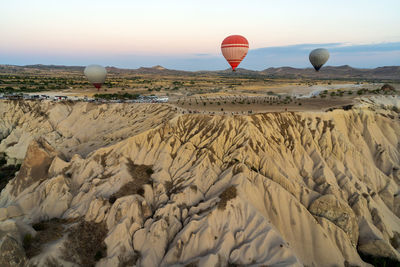 Wide angle view of hot air balloons against unique geological formations due to volcanic acitivity