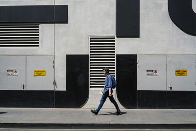 Woman standing on footbridge