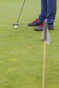 Low section of man playing golf