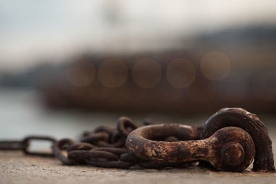 Close-up of rusty chain on table