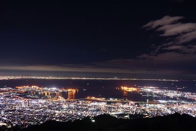 Illuminated cityscape against sky at night