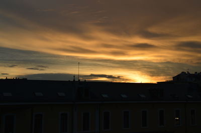 Low angle view of silhouette buildings against sky during sunset