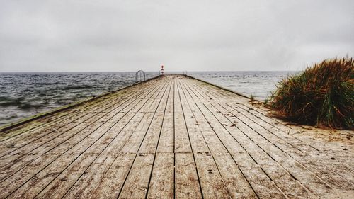 Pier over sea against sky