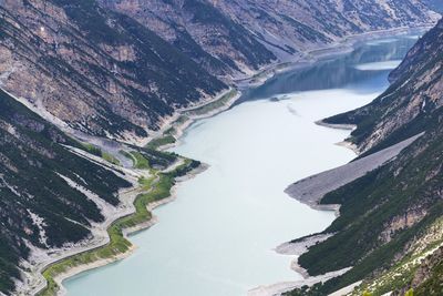 Car tunnel on bank of livigno lake in alps, italy