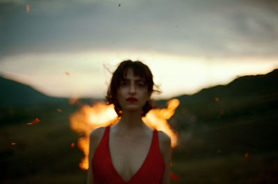 Portrait of girl standing against sky during sunset