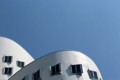 Low angle view of building against clear blue sky