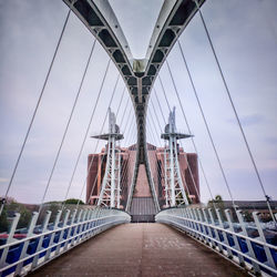 Suspension bridge against sky in city