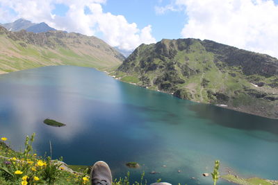 Scenic view of lake and mountains against sky