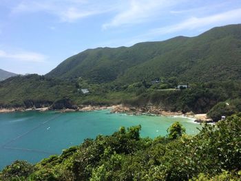 Scenic view of lake by mountains against sky