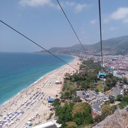 High angle view of townscape by sea against sky