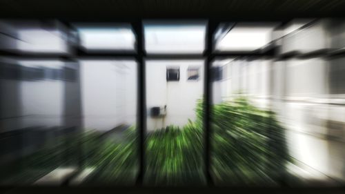Blurred motion of building seen through train window