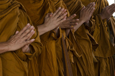 Midsection of monks praying