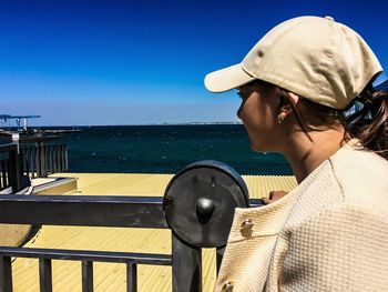 Portrait of woman against sea against sky