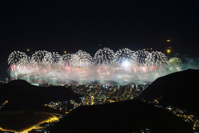 Low angle view of firework display at night