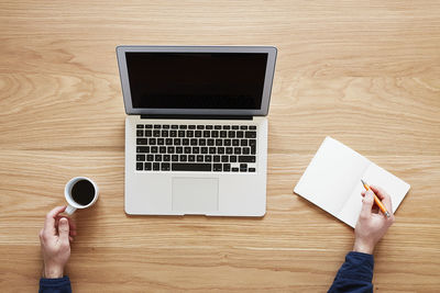 Man using laptop, directly above