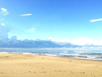 Scenic view of beach against blue sky