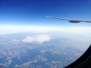 Aerial view of landscape against blue sky