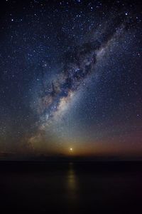 Idyllic shot of milky way over sea against sky