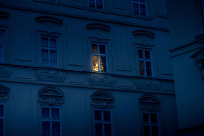 Low angle view of illuminated building at dusk