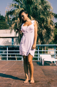 Full length of woman standing in swimming pool