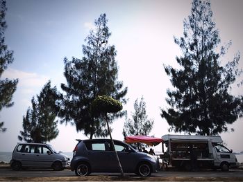 Cars parked on street against sky