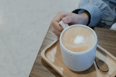 Midsection of coffee cup on table