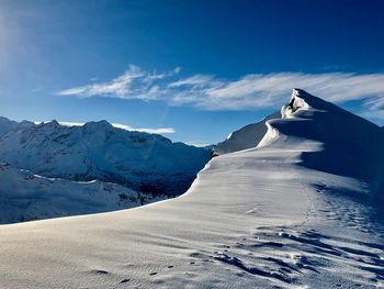 Scenic view of snow covered mountains against sky