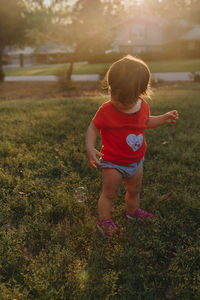 Full length of girl standing on grass