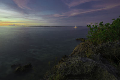 Scenic view of sea against sky at sunset